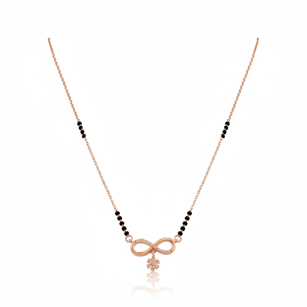 Rose gold infinity mangalsutra with black bead chain, diamond-studded infinity symbol and floral drop pendant on white background