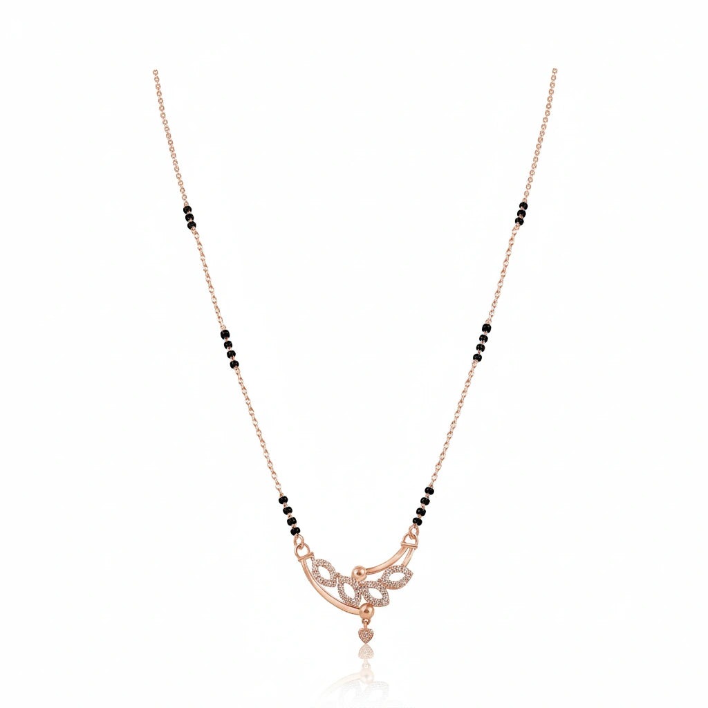 Short fancy rose gold mangalsutra with black bead chain and diamond-studded floral scroll pendant with heart drop on white background
